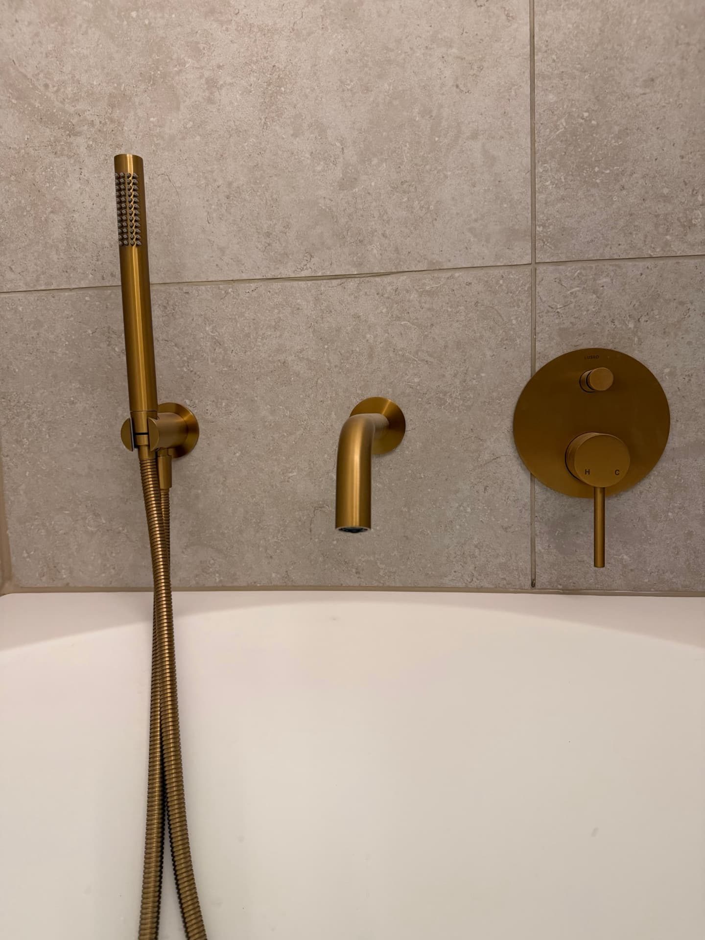 Brushed brass shower and bath fittings in the finished bathroom